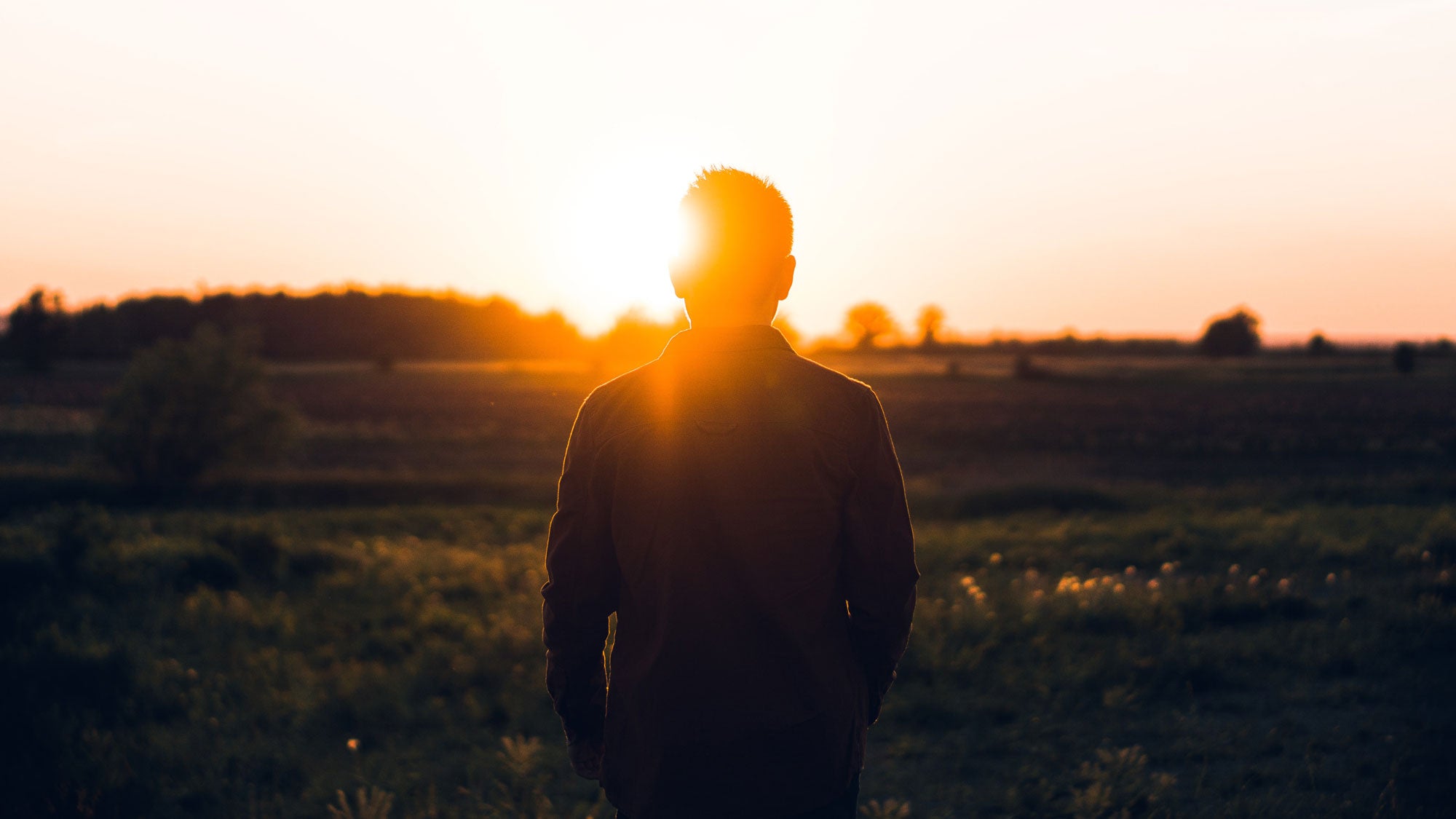 Man looking watching the sunrise
