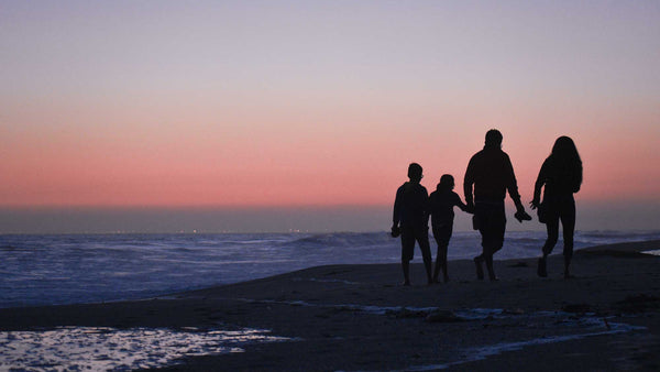 Family walking on beach 